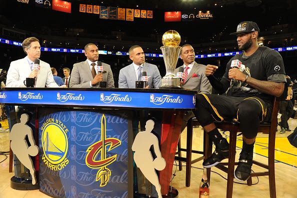OAKLAND, CA - JUNE 19: Matt Winer, Steve Smith, Grant Hill and Isiah Thomas interview LeBron James #23 of the Cleveland Cavaliers while he celebrates with the Larry O'Brien NBA Championship Trophy after winning Game Seven of the 2016 NBA Finals against the Golden State Warriors on June 19, 2016 at ORACLE Arena in Oakland, California. NOTE TO USER: User expressly acknowledges and agrees that, by downloading and/or using this Photograph, user is consenting to the terms and conditions of the Getty Images License Agreement. Mandatory Copyright Notice: Copyright 2016 NBAE (Photo by Andrew D. Bernstein/NBAE via Getty Images)