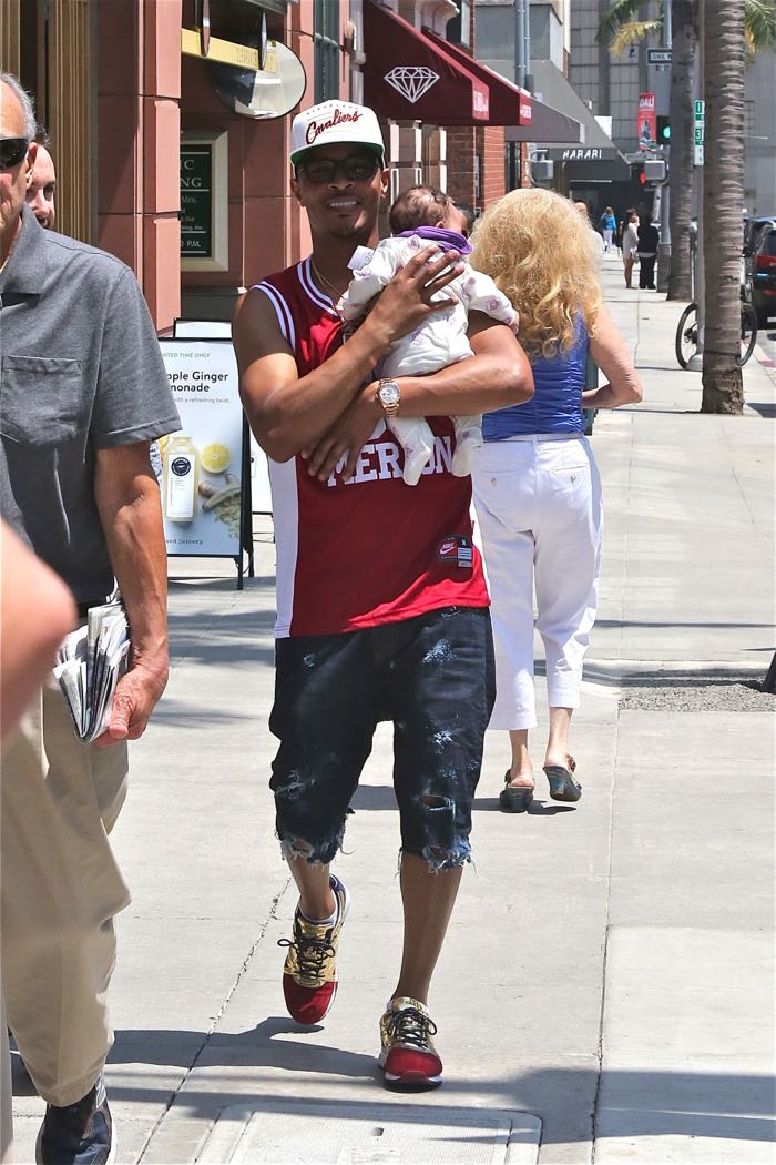 T.I., wearing a Clevland Cavaliers cap and Kobe Bryant Lower Merion basketball jersey, out for a walk with his newborn daughter on a sunny day in Beverly Hills Featuring: T.I., Heiress Harris Where: Los Angeles, California, United States When: 27 Jun 2016 Credit: WENN.com
