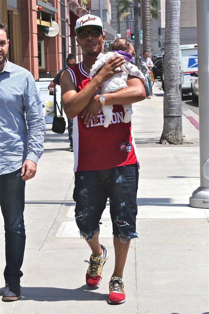T.I., wearing a Clevland Cavaliers cap and Kobe Bryant Lower Merion basketball jersey, out for a walk with his newborn daughter on a sunny day in Beverly Hills Featuring: T.I., Heiress Harris Where: Los Angeles, California, United States When: 27 Jun 2016 Credit: WENN.com