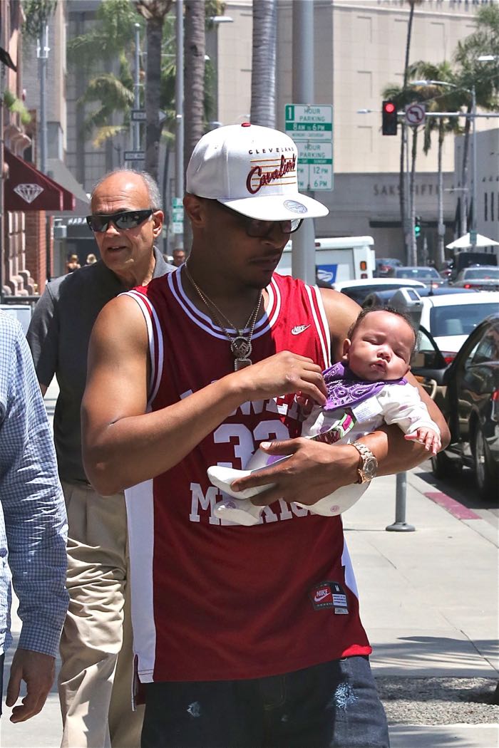 T.I., wearing a Clevland Cavaliers cap and Kobe Bryant Lower Merion basketball jersey, out for a walk with his newborn daughter on a sunny day in Beverly Hills Featuring: T.I., Heiress Harris Where: Los Angeles, California, United States When: 28 Jun 2016 Credit: WENN.com