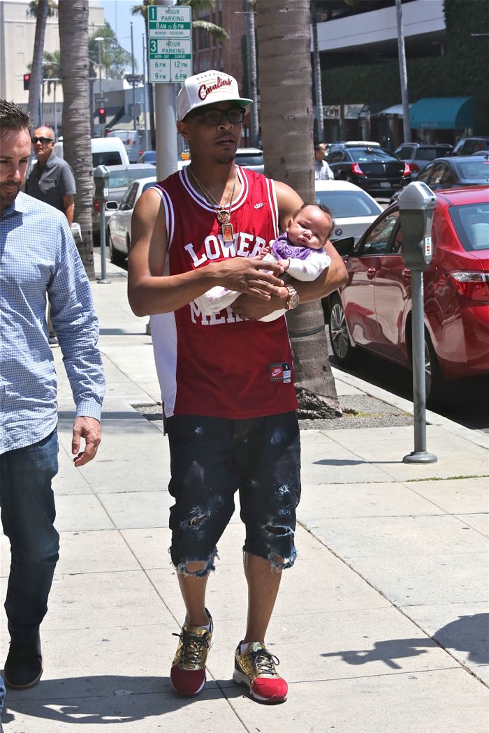 T.I., wearing a Clevland Cavaliers cap and Kobe Bryant Lower Merion basketball jersey, out for a walk with his newborn daughter on a sunny day in Beverly Hills Featuring: T.I., Heiress Harris Where: Los Angeles, California, United States When: 28 Jun 2016 Credit: WENN.com