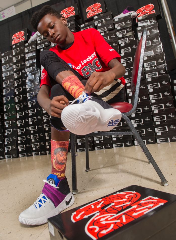 De'Lon Bush, 12, of Cleveland, tries on his Nike Kyrie II signature shoes, Saturday, July 9, 2016, in Independence, Ohio. Kids Foot Locker donated 190 pairs of sneakers to Boys & Girls Clubs of Cleveland, to match Cleveland Cavaliers star Kyrie Irving's 190 points scored during the NBA championship series. (Phil Long/AP Images for Kids Foot Locker)