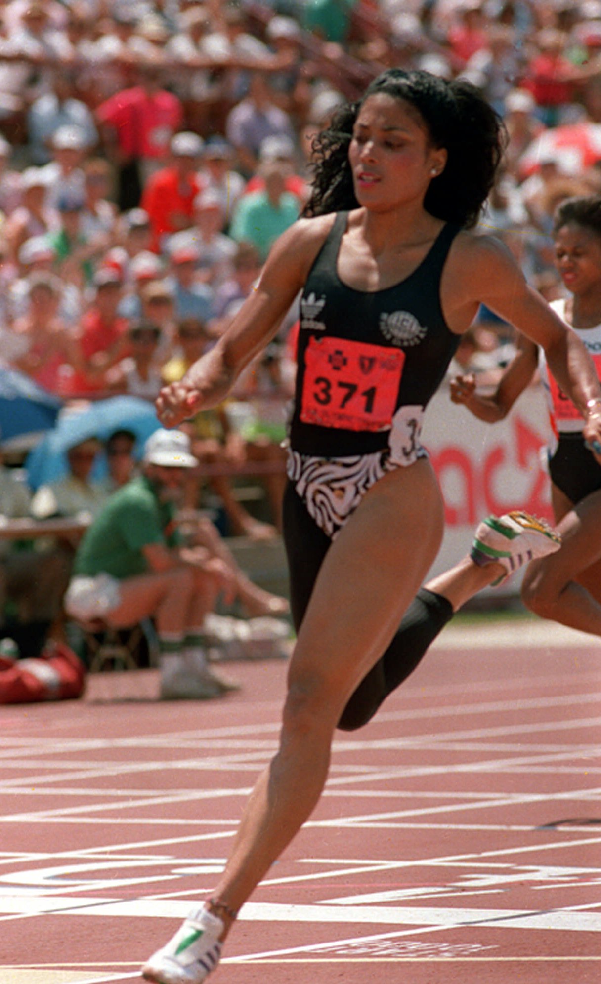 Florence Griffith Joyner runs in a preliminary heat of the women's 200-meters at the U.S. Olympic Track and Field trials in Indianapolis on August 13, 1988.  (AP Photo/Al Behrman)