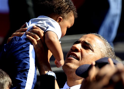 President Barack Obama holds a baby as he greets supporters during a campaign rally in Byrd Park in Richmond, Va., Thursday, Oct. 25, 2012. The president is on the second day of his 48 hour, 8 State campaign blitz. (AP Photo/Steve Helber)