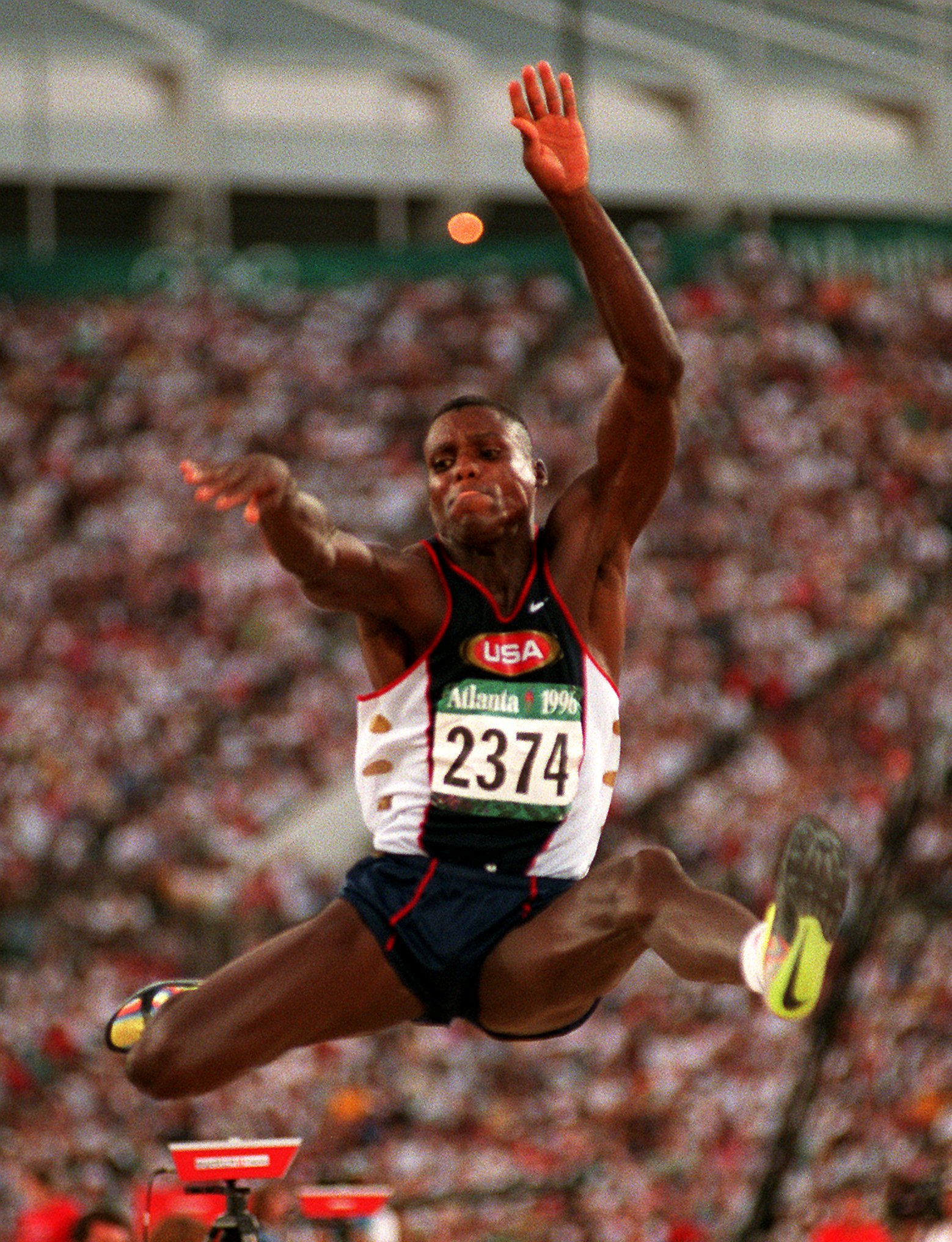 Carl Lewis of the United States takes his third jump during the men's long jump final at the 1996 Summer Olympic Games in Atlanta, Monday, July 29, 1996. Lewis won the gold medal. (AP Photo/Lynne Sladky)