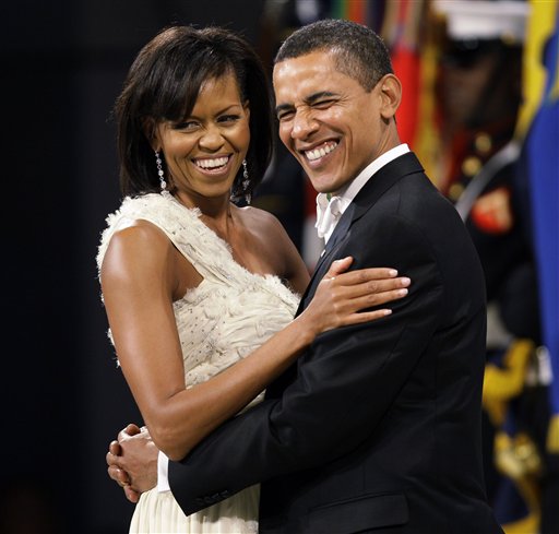 FILE - In this Jan. 20, 2009, file photo, President Barack Obama and first lady Michelle Obama dance at the Western Inaugural Ball in Washington. Turning 50 is hard enough. But it's got to be even harder when you're president, because the whole world knows about it. "I feel real good about 5-0," he said. "I've gotten a little grayer since I took this job but otherwise, I feel pretty good." Obama added that Michelle has told him that she still thinks "I'm cute." (AP Photo/Charlie Neibergall, File)