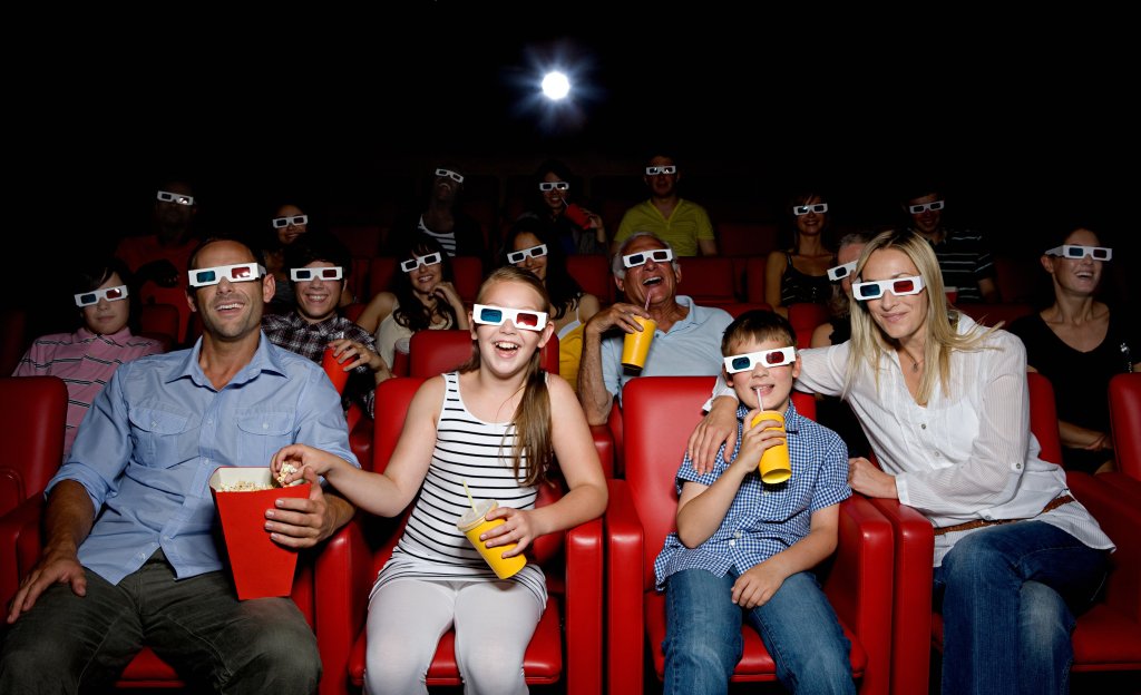Family watching 3d movie at the movie theater