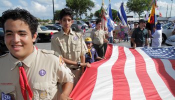 Boy scouts marching with a flag at Arts in the Street, Independence of Central America & Mexico Cultural Integration Day.
