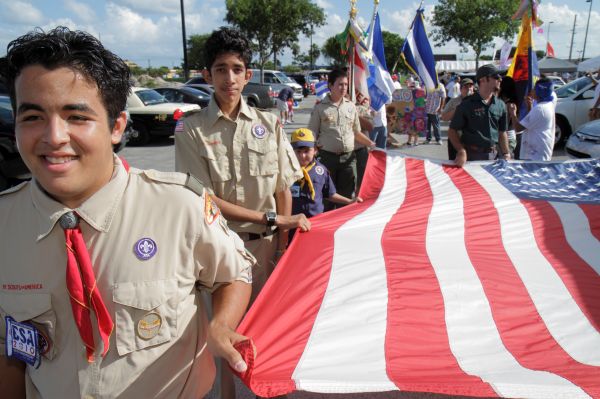 Boy scouts marching with a flag at Arts in the Street, Independence of Central America & Mexico Cultural Integration Day.