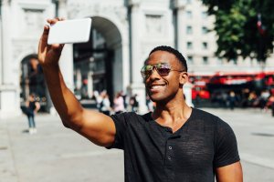 Handsome black guy, taking selfie for social media