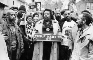 The Rev. Al Sharpton (c.) flanked by Diane Hawkins and Moses