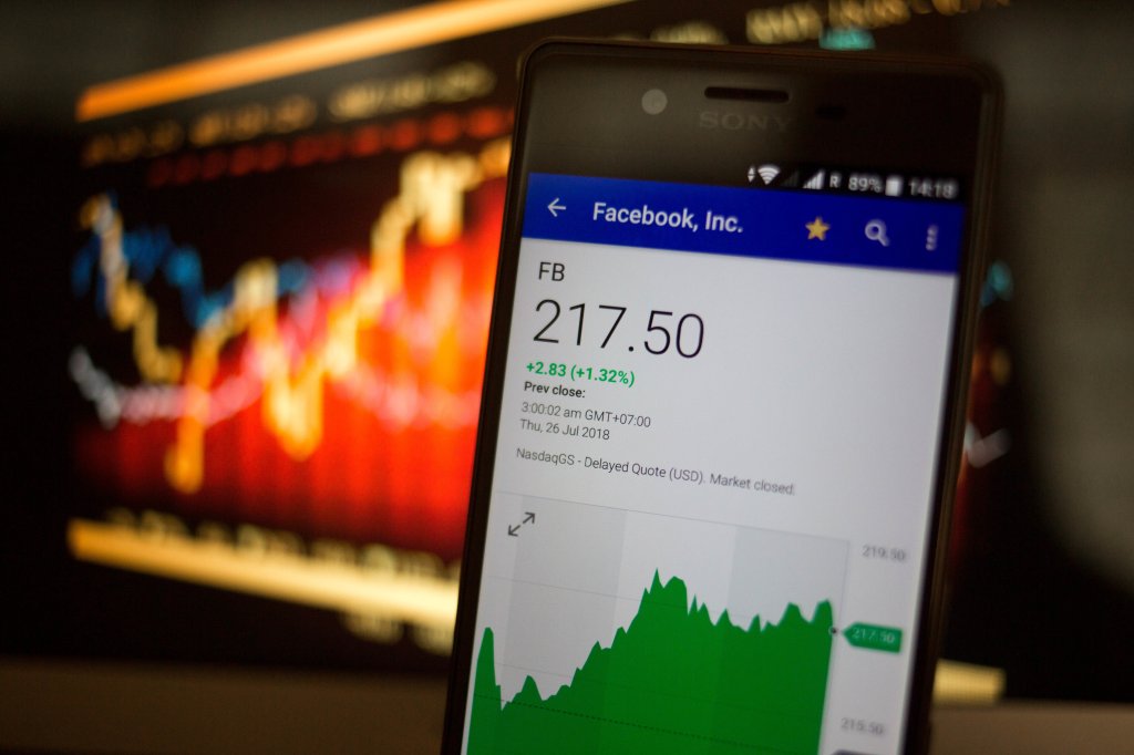 A smartphone displays the Facebook, Inc. market value on the...
