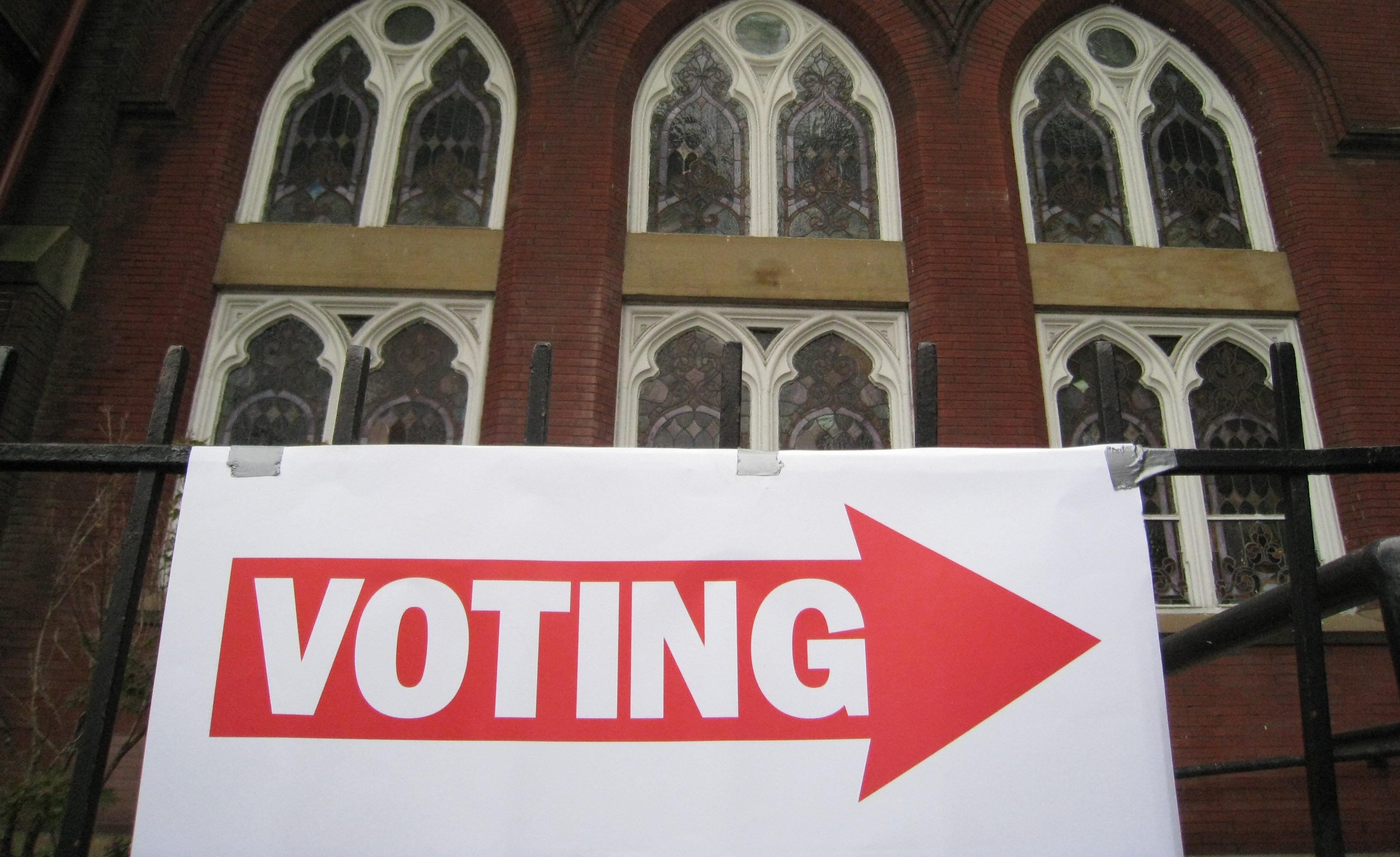 A sign pointing to a polling station is