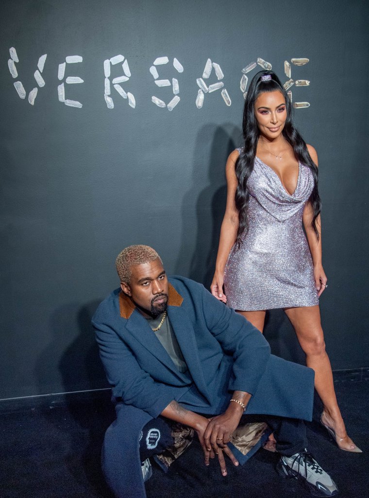 'Ye gets in his bag for the photogs.