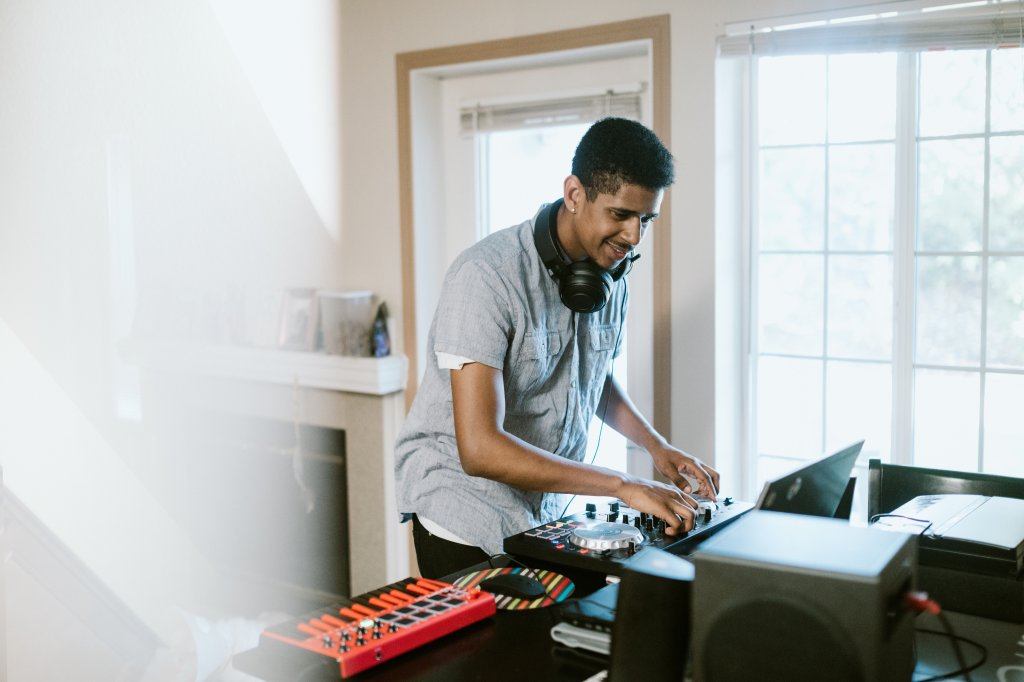 Young Adult Man Practicing His Live DJ Set at Home