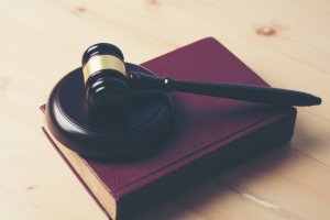 High Angle View Of Book And Gavel On Table