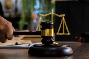 Law and justice concept. Judge's gavel, scales, hourglass, books.