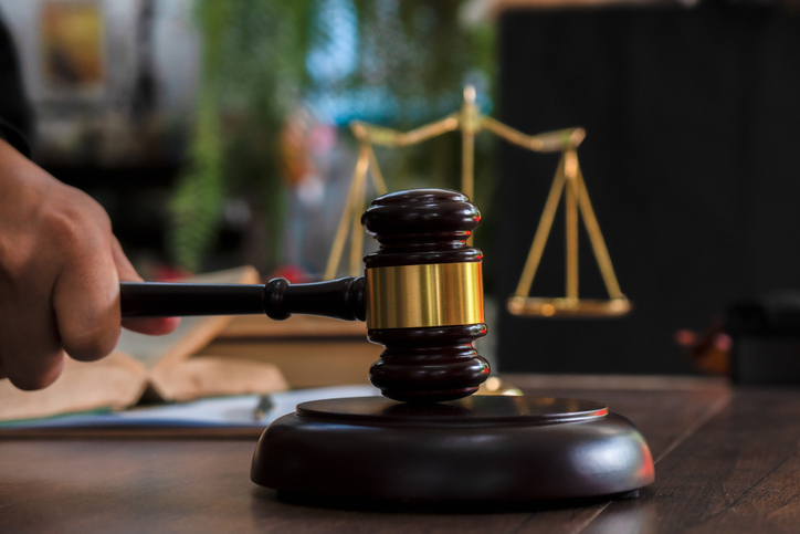 Law and justice concept. Judge's gavel, scales, hourglass, books.