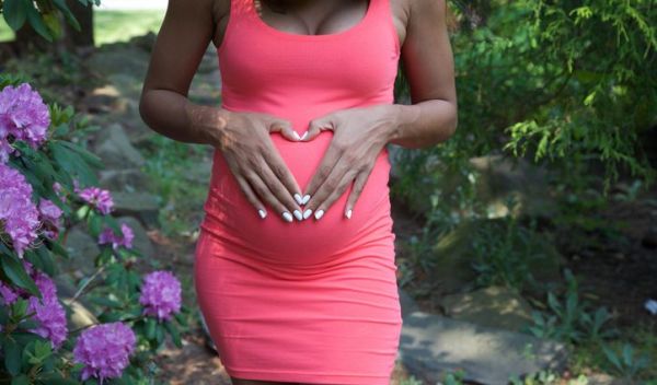 black pregnant woman outdoors