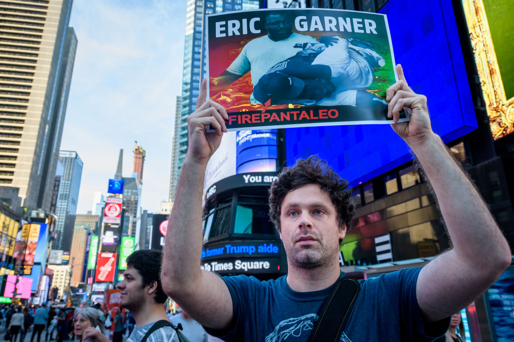 A protester holding a placard during the protest rally of...