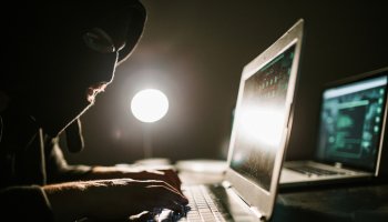 Man hacking and committing internet crime by using laptops