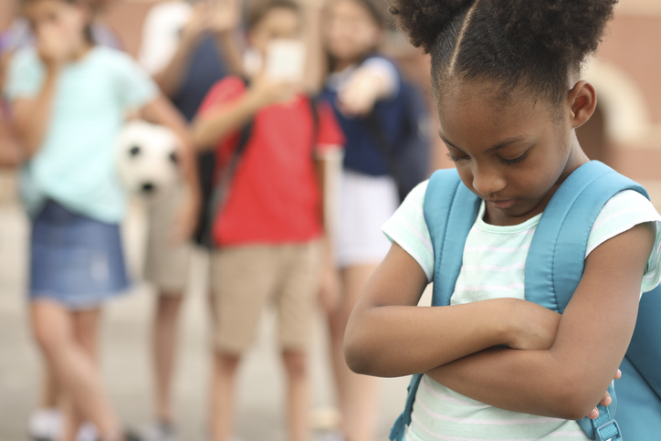 Elementary age, African American girl being bullied at school.