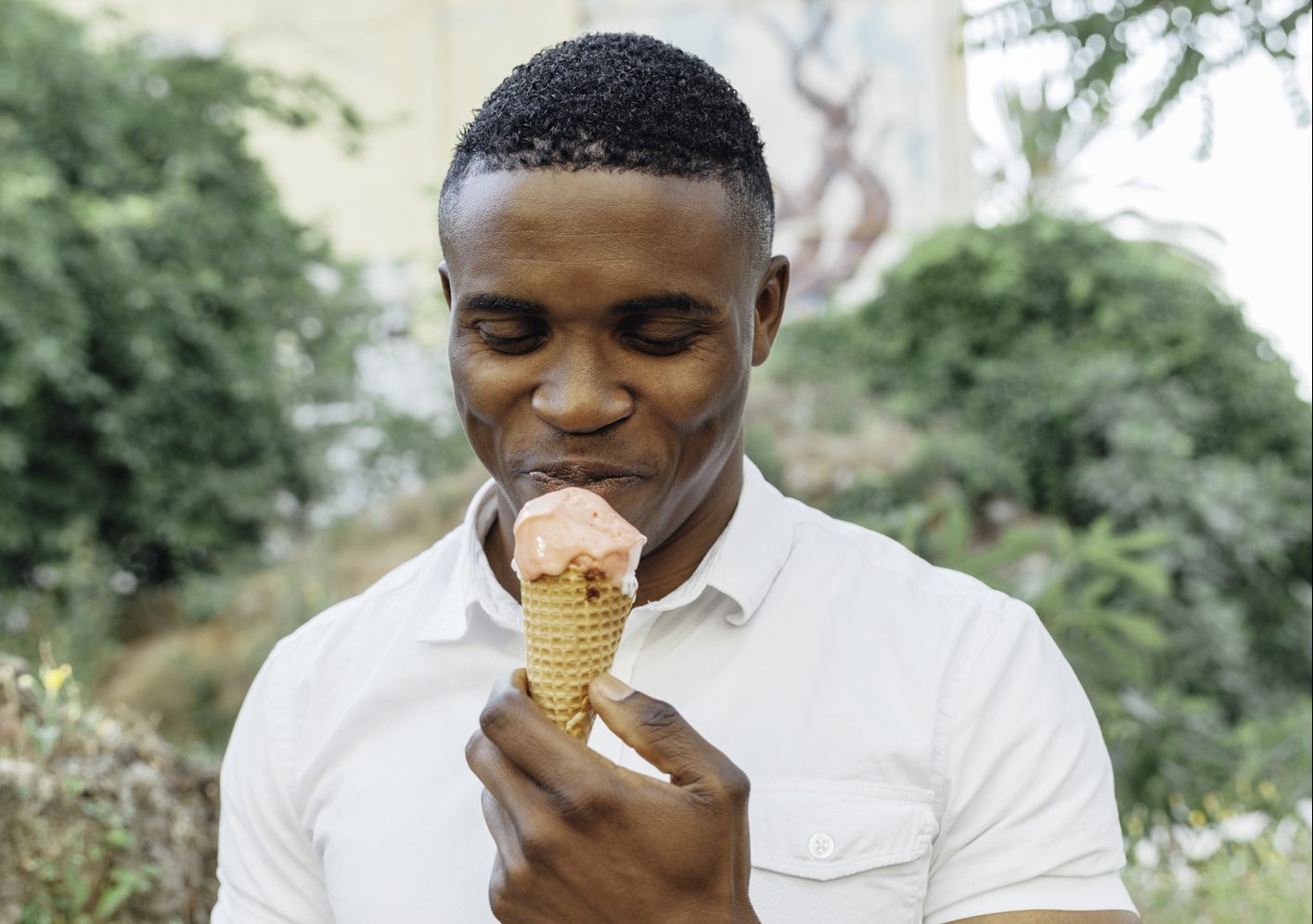 Portrait of handsome man eating ice cream