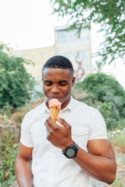 Portrait of handsome man eating ice cream