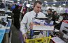 Profile of Mike Ersfeld, general manager of a Best Buy store in Eden Prairie, as copes with the pressure of Black Friday shopping. Ersfeld hands out store maps to customers waiting in line outside the store, greets them as they enter at midnight, and ans