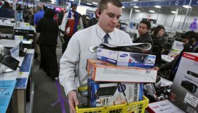 Profile of Mike Ersfeld, general manager of a Best Buy store in Eden Prairie, as copes with the pressure of Black Friday shopping. Ersfeld hands out store maps to customers waiting in line outside the store, greets them as they enter at midnight, and ans