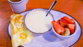 Grits, eggs, strawberries, bananas, and tea for breakfast in New Orleans