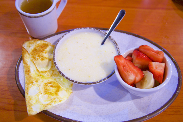 Grits, eggs, strawberries, bananas, and tea for breakfast in New Orleans
