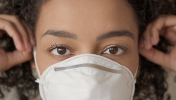 Close-Up Portrait Of Woman Wearing Pollution Mask