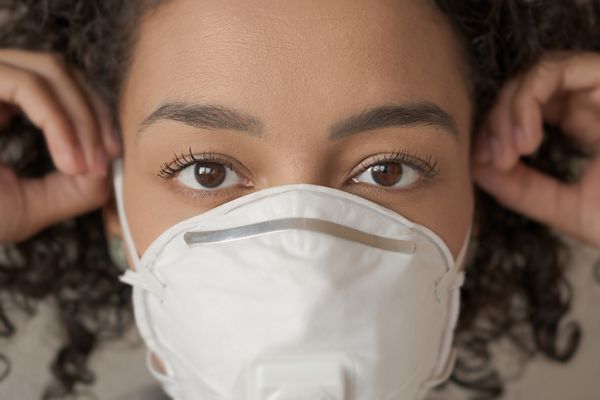 Close-Up Portrait Of Woman Wearing Pollution Mask