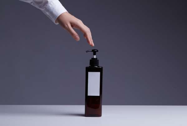 Human Hand Touch Shampoo Or Lotion Or Dishwashing Liquid In Pump Bottle,Product Shot.