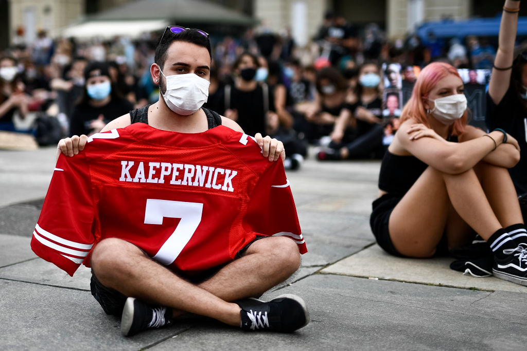 A protester holds a shirt of Colin Kaepernick during a...
