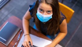 Female High School Student in Classroom Setting Wearing Mask