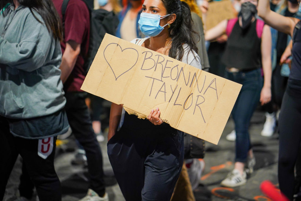 A protester holds a placard expressing her opinion during...