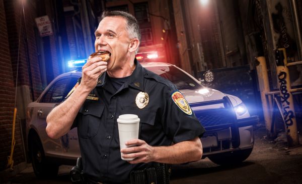 Police Officer Eating Donut in Alley