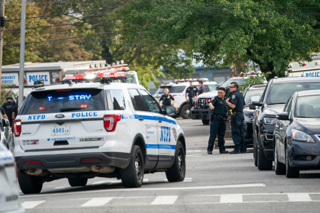 NYPD officers seen on the shooting scene. Police from 109th...