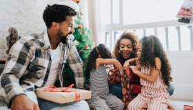 Family celebrating Christmas at home with gifts