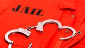 Orange prisoner's jumpsuit, with handcuffs