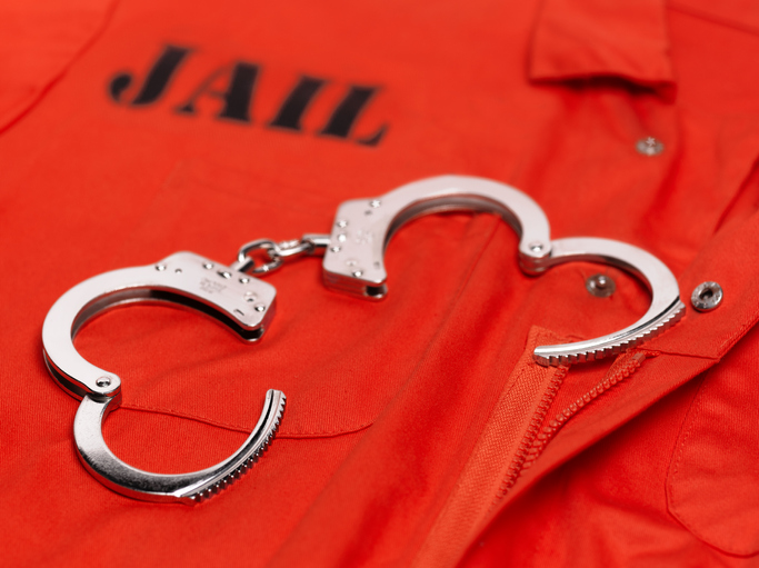 Orange prisoner's jumpsuit, with handcuffs