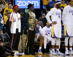 Musician Diddy, center, watches the Golden State Warriors game against the Cleveland Cavaliers next to the Warriors bench in the fourth quarter of Game 5 of the NBA Finals at Oracle Arena in Oakland, Calif., on Monday, June 12, 2017. (Nhat V. Meyer/Bay A