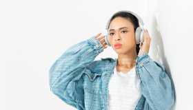A woman listening to music with headphones.