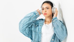A woman listening to music with headphones.