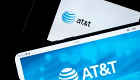 In this photo illustration, AT&T logos seen displayed on...