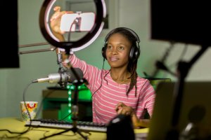 Young black woman recording a business podcast