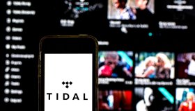 In this photo illustration a Tidal logo seen displayed on a...