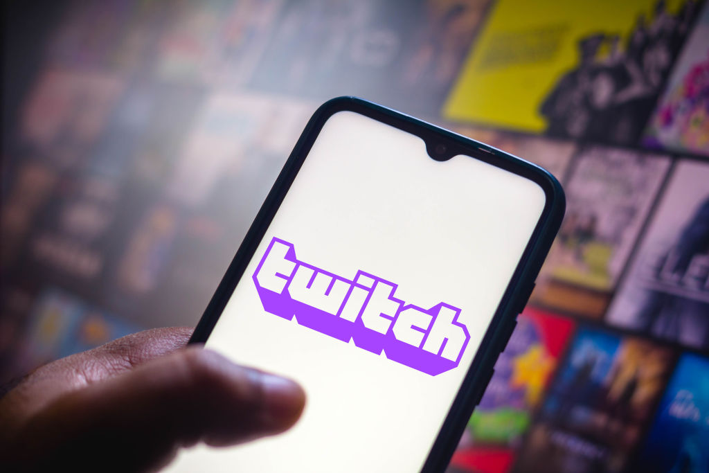 In this photo illustration the Twitch logo seen displayed on...
